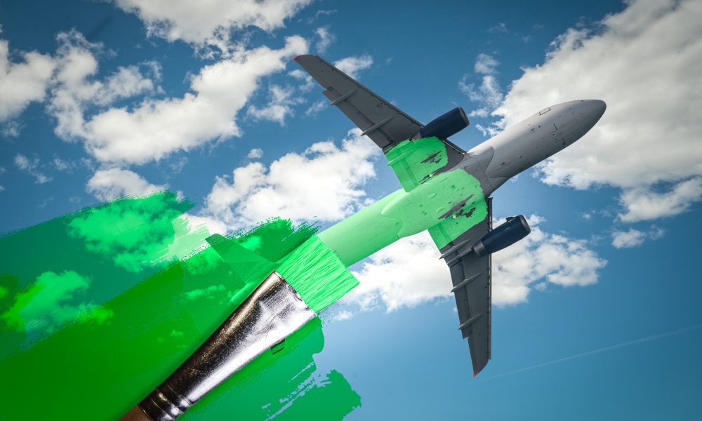 brush painting green an aircraft. Greenwashing malpractice, Zero emissions, SAF or Sustainable Aviation Fuel, Circular economy, net CO2 emissions or biofuel concepts.