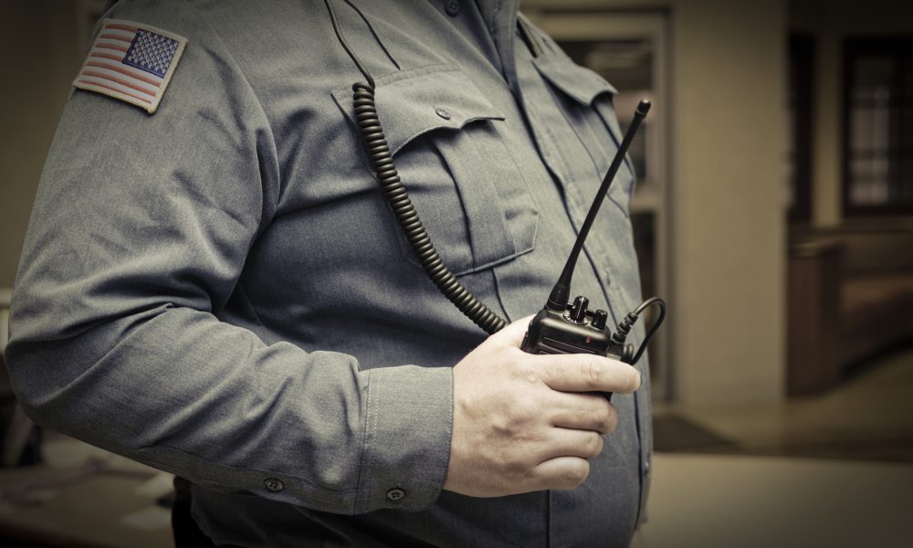 Security guard with walkie talkie in hand