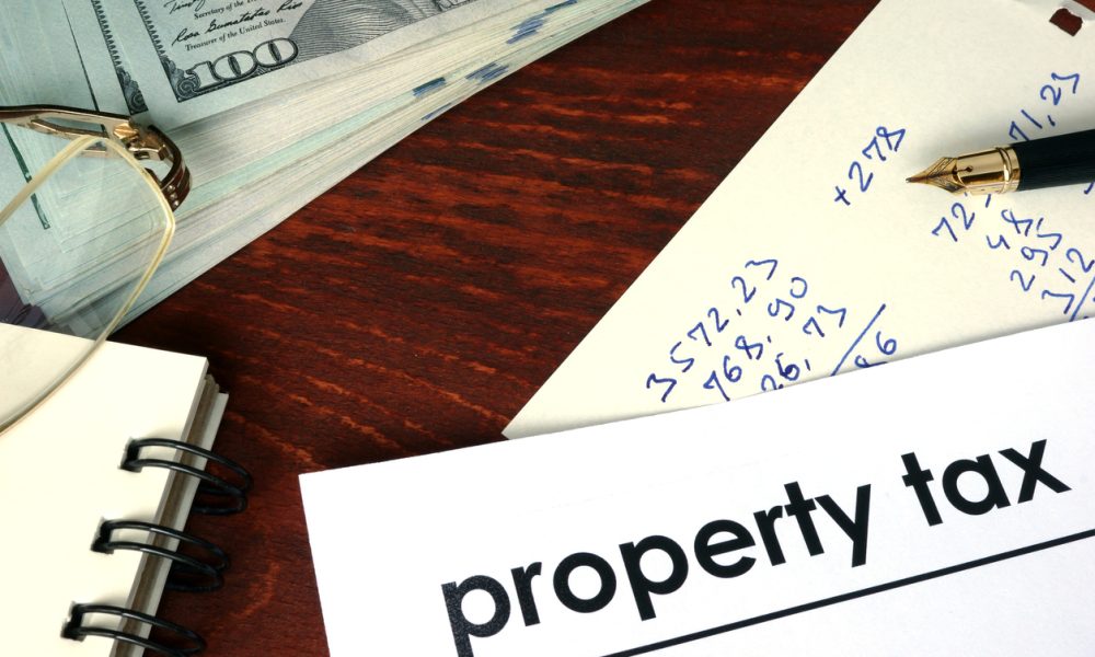 Property tax written on a paper. Financial concept.
