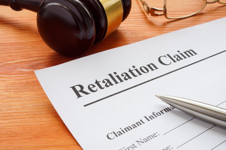 Retaliation claim lying on the desk with gavel.
