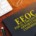 Equal Employment Opportunity Commission EEOC on a desk - HospitalityLawyer.com®